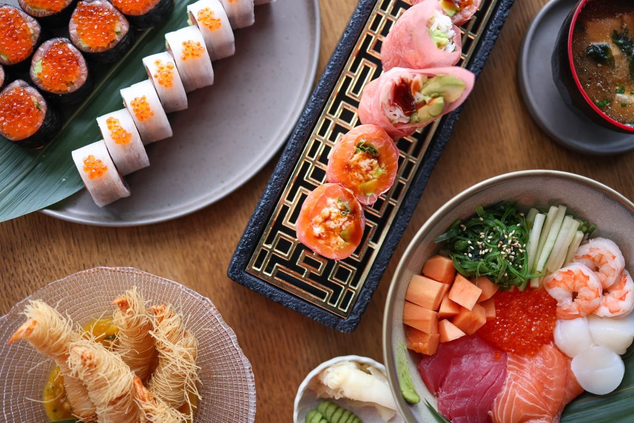 Colorful display of assorted Japanese sushi and sashimi with vibrant ingredients.